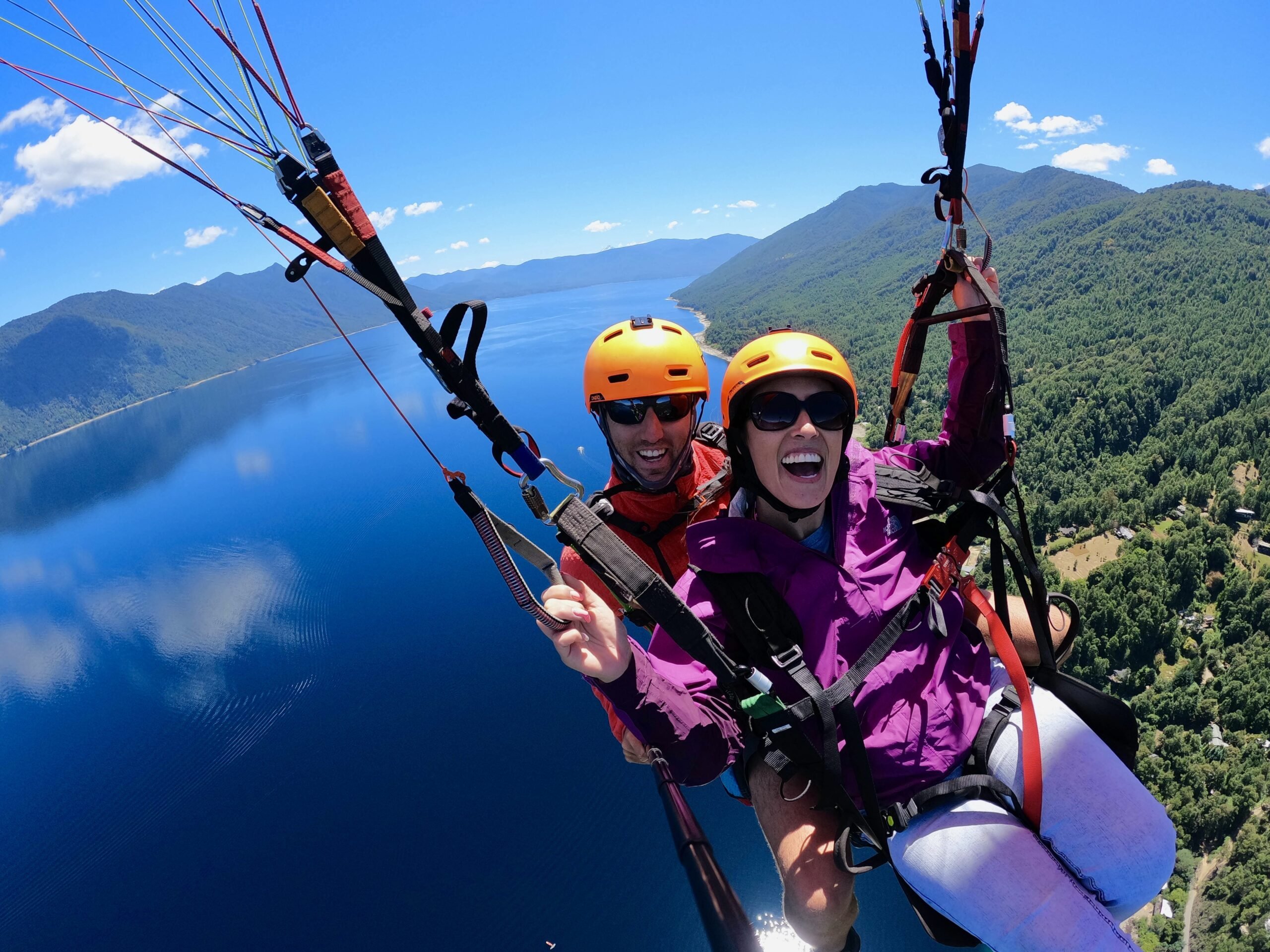 Paraglider flying over mountain clouds